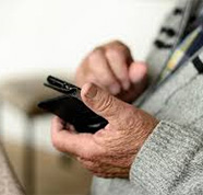 older man holding phone