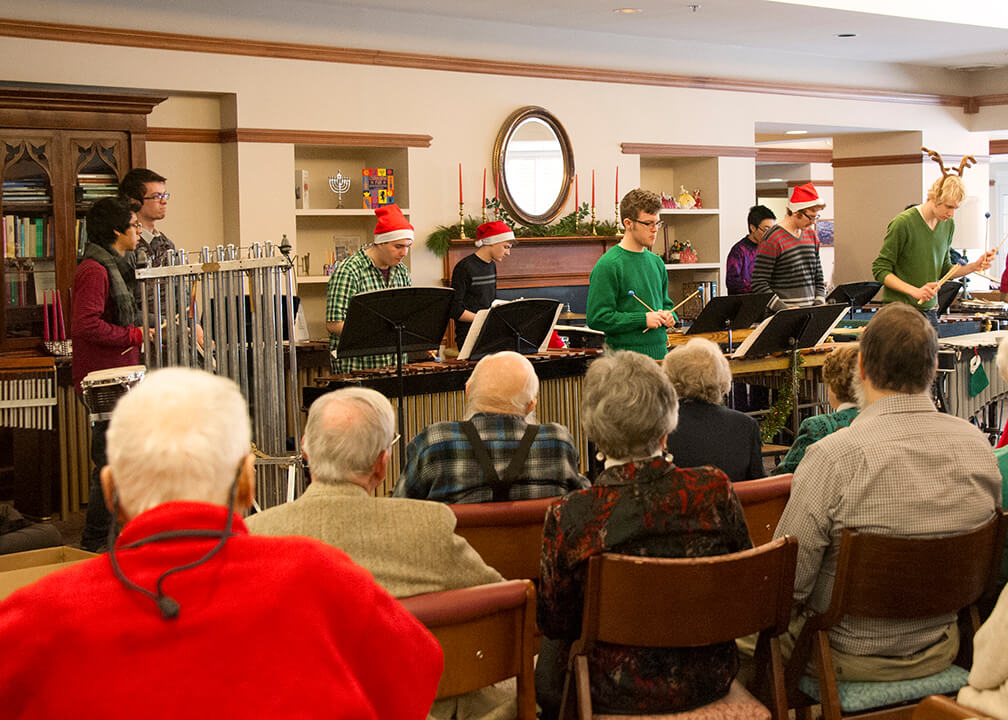 group playing instruments in front of audience