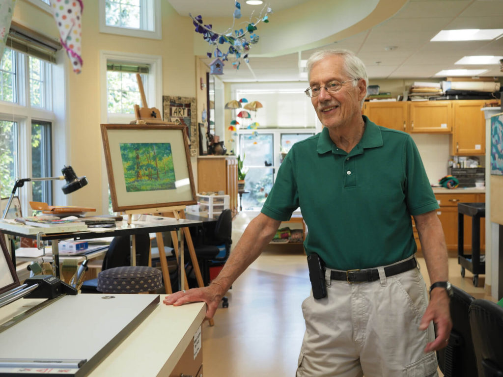 man standing next to painting 
