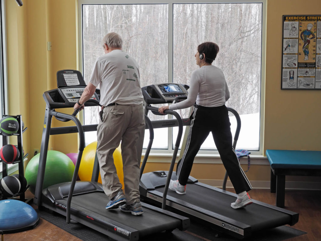 man and woman on treadmills 