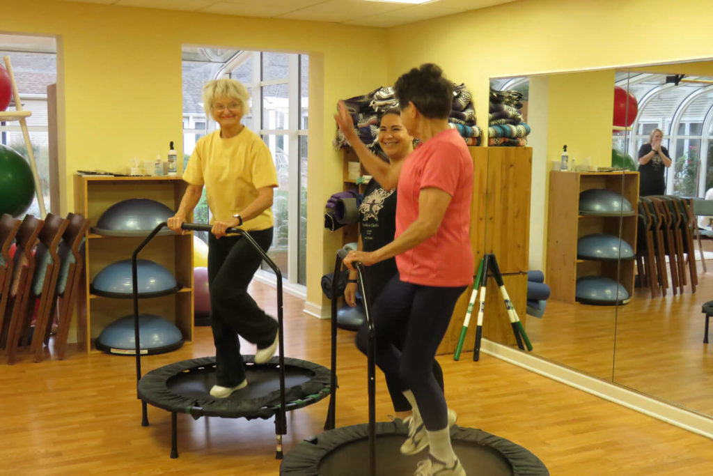 two woman on small trampolines 