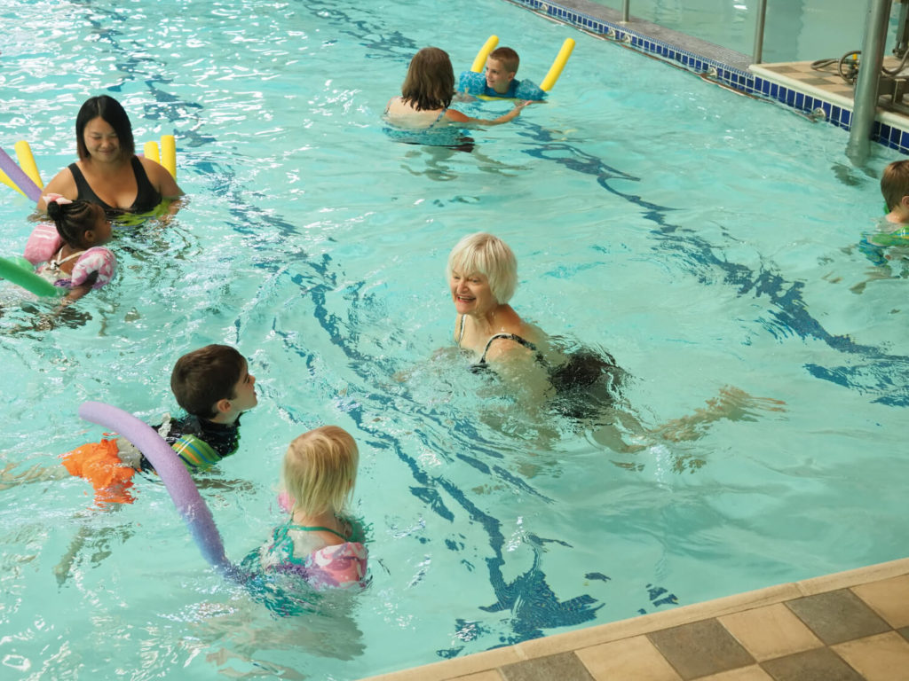 group and people swimming in pool 