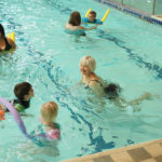 seniors and children play in pool