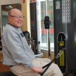 older man exercising in fitness center