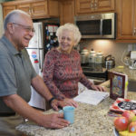 senior couple cooking in kitchen