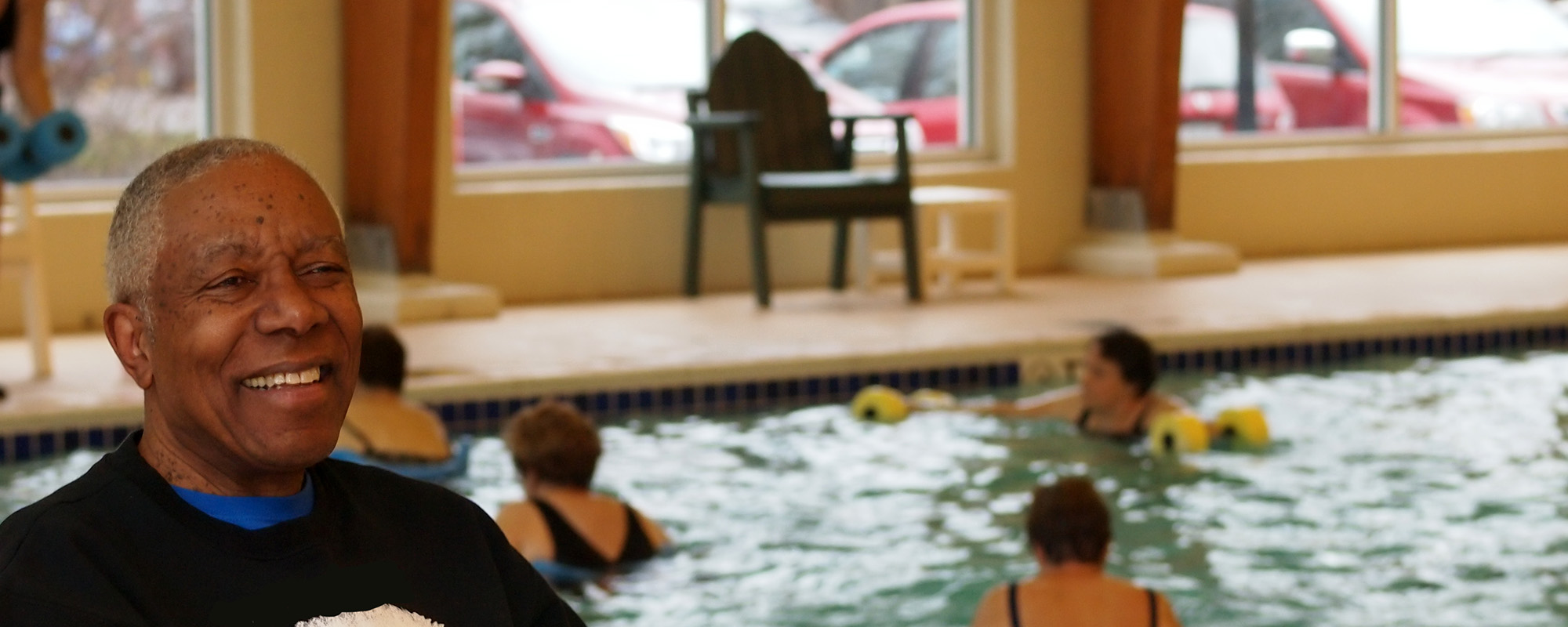 older man by swimming pool