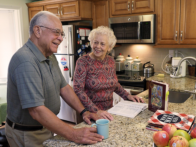 couple in cottage kitchen preparing a meal
