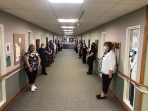 staff stands in silent reflection on peace and inclusion