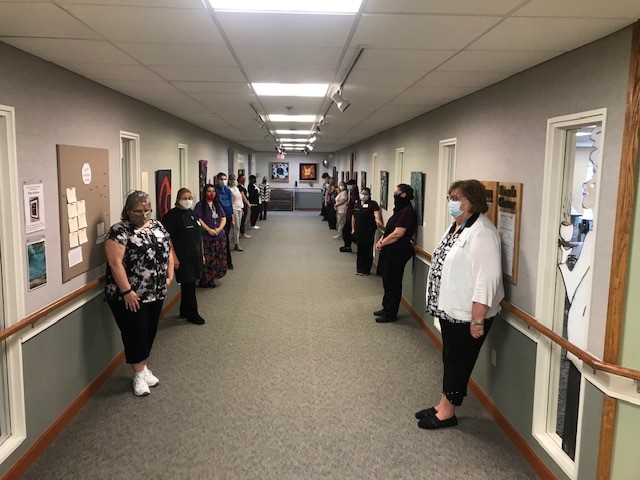 staff stands in silent reflection on peace and inclusion