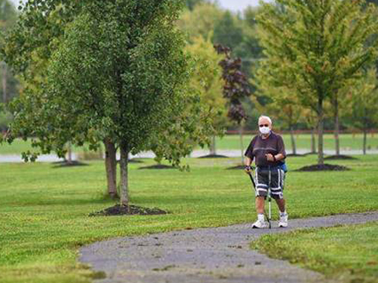 older man walking in a park