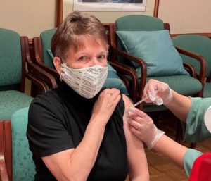Woman gets COVID-19 vaccine