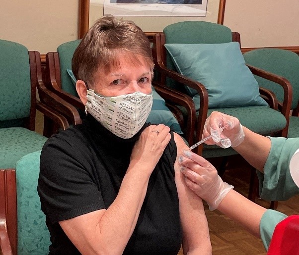 Woman gets COVID-19 vaccine