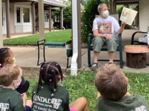 older adult reads to children