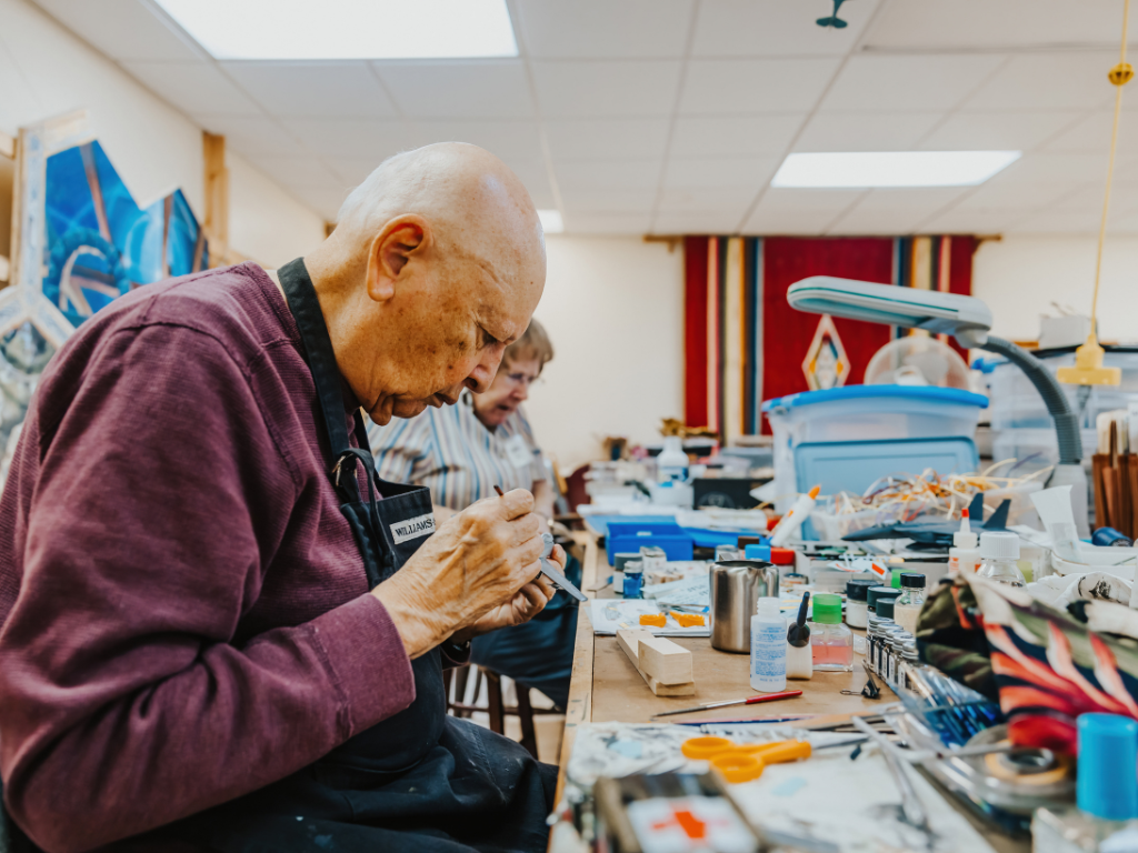 man working on model airplane