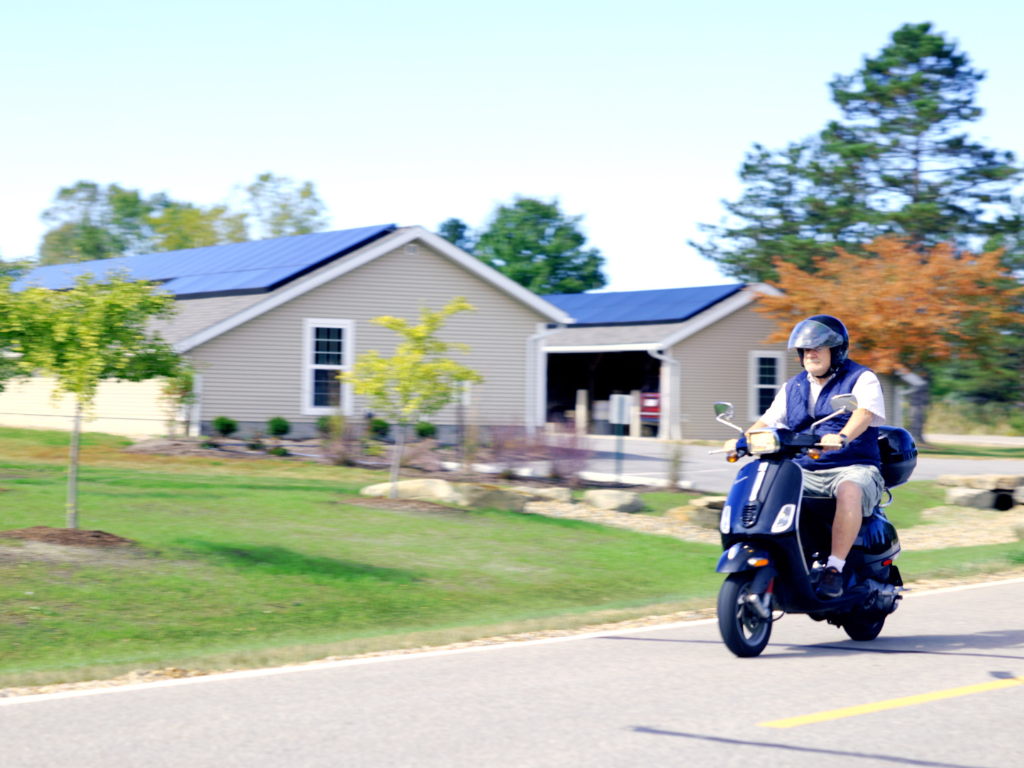 man driving Vespa 