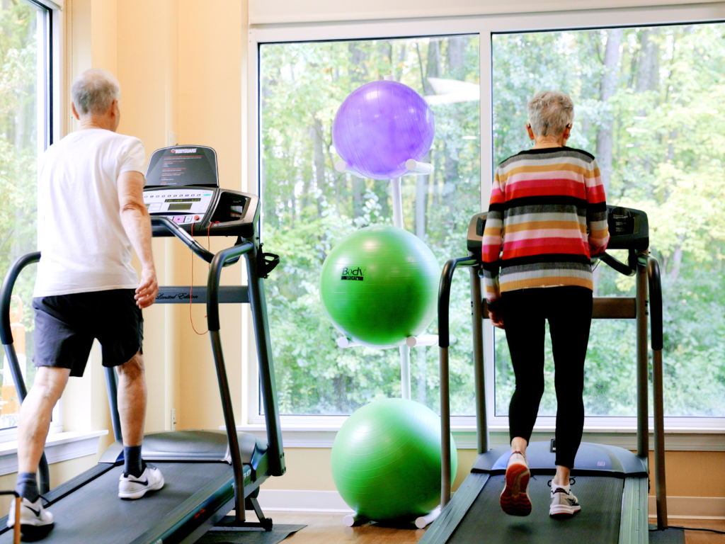 man and woman on treadmills