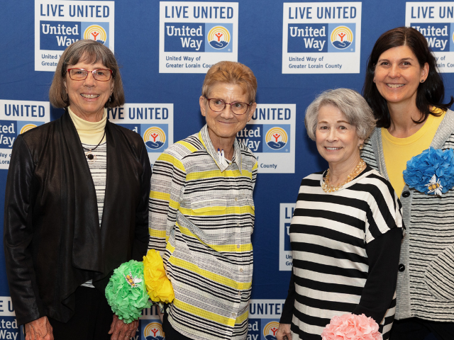 four woman standing together