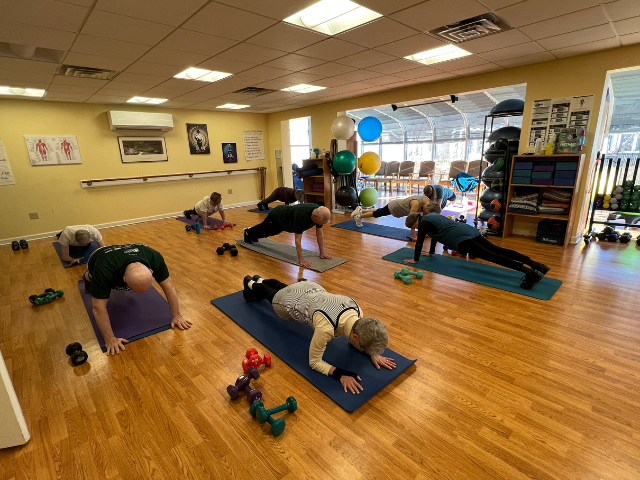 group fitness class holding planks  