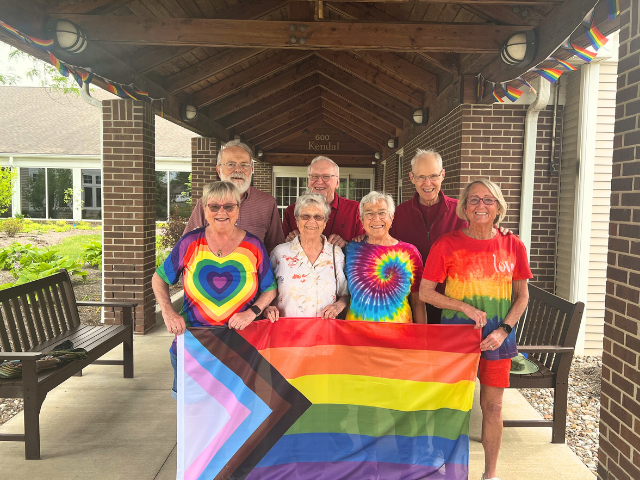 group holding pride flag