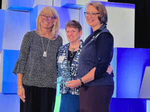 3 women on stage - award ceremony