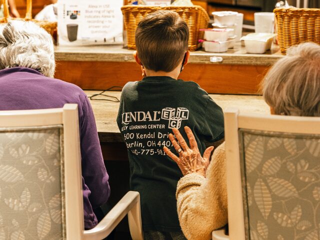 woman sitting with hand on child's back