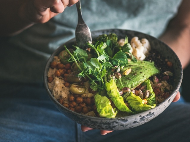 hand holding a grain bowl 