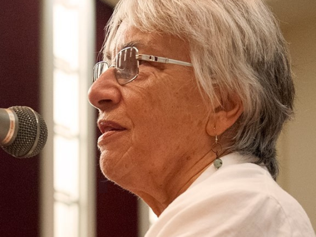 woman speaking into microphone