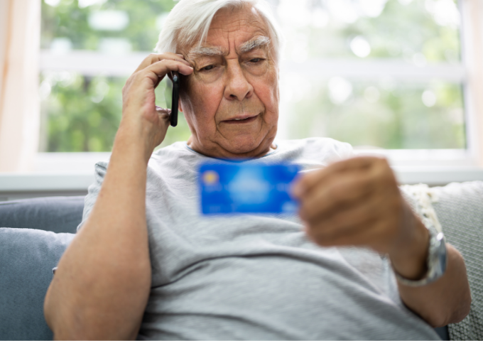 man holding phone and credit card