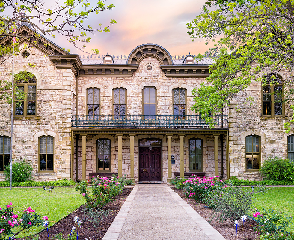Fredericksburg Memorial Library in Texas showing the front of the building with landscaping