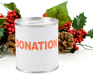  Donation can that is surrounded by festive holiday plants.